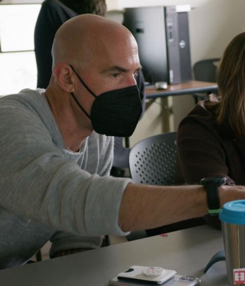 Thom Long in class teaching a student.