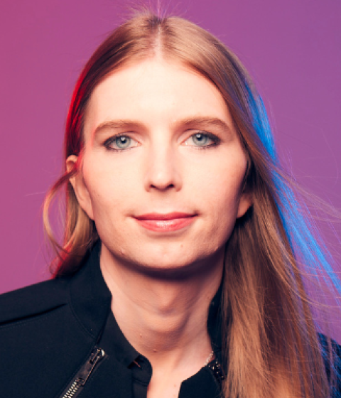 Headshot of Chelsea E. Manning with a pink and purple background.
