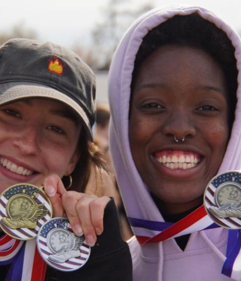 Womens Track and Field winners hold up awards