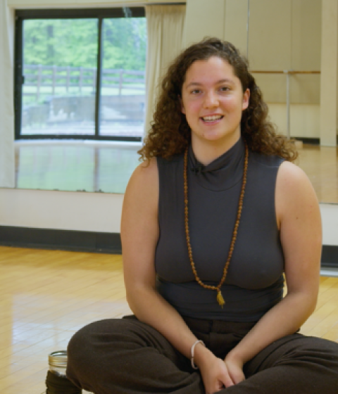 On the left: Yarrow sits cross-legged on the dance studio floor wearing a grey tank top. On the right: A still from Yarrow's dance performance, "This Medicine is Good."