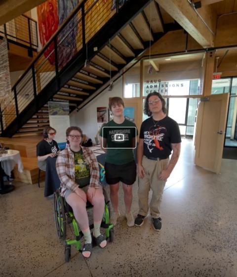 Still from virtual tour featuring three students in the center of the R.W. Kern Center lobby