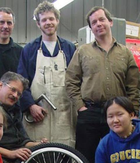 Students and teachers in the Center for Design smiling at the camera