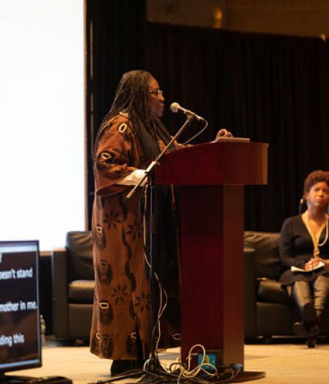 Safia Omari speaking to a crowd at the Eqbal Ahmad Symposium