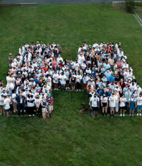 students making the shape of an H