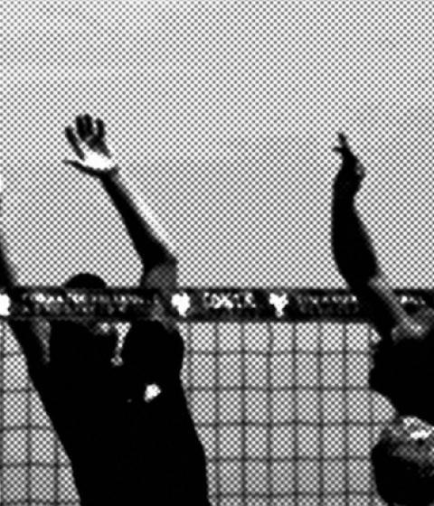 Black and white photo of people playing volleyball