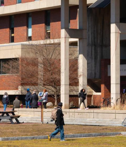 Students outside the library on a spring day March 2019