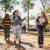 Students chat and walk together outside on campus.