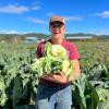 Emily Landeck holding a cabbage on the farm.